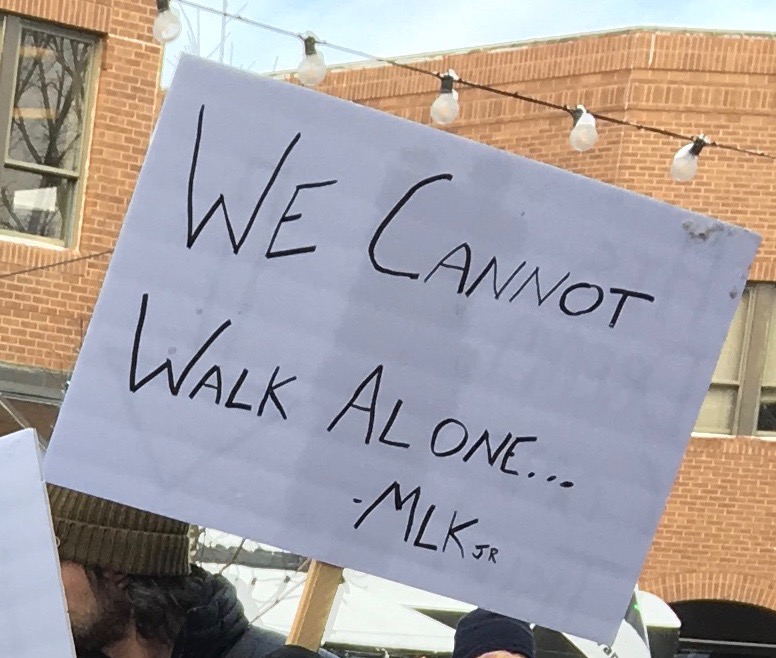 Sign saying "We Cannot Walk Alone... - MLK 