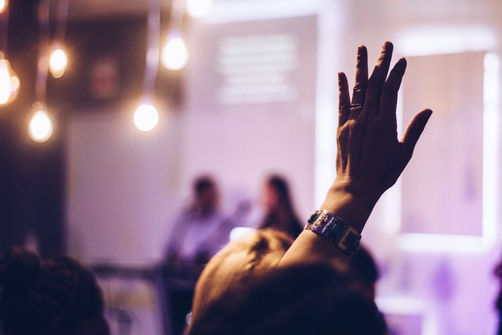 hand raised in a crowd